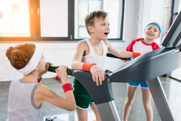 kids in sportswear training on treadmill - Zdjęcie, obraz