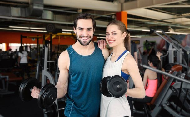 young couple with dumbbells - Photo, Image