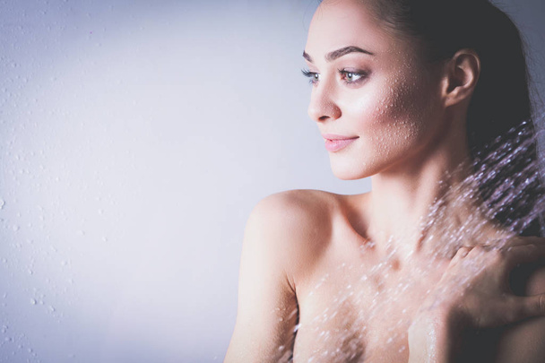 Young beautyful woman under shower in bathroom - Foto, Imagen