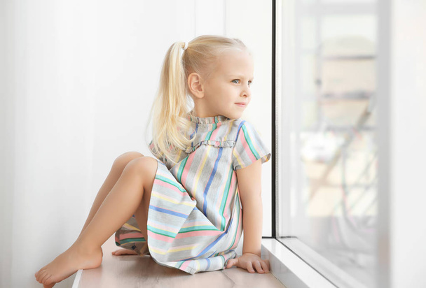 girl sitting on windowsill - Foto, Imagem