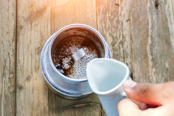 verter agua caliente en granos de café molidos en filte
 - Foto, Imagen