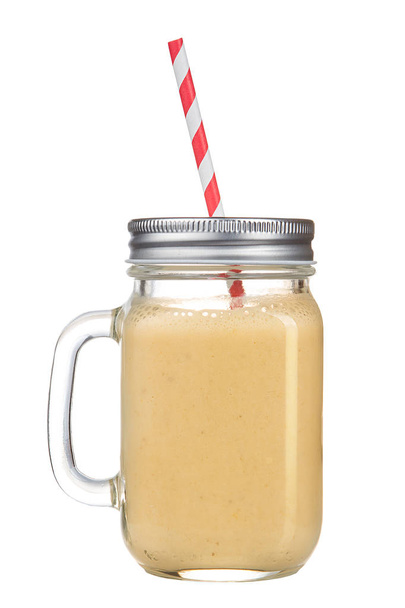 Healthy refreshing fruit smoothie with straw in a jar mug isolated on white. - Zdjęcie, obraz