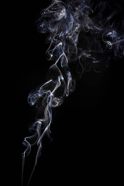 Freeze motion of smoke on black background.  Abstract vape clouds. - Фото, изображение