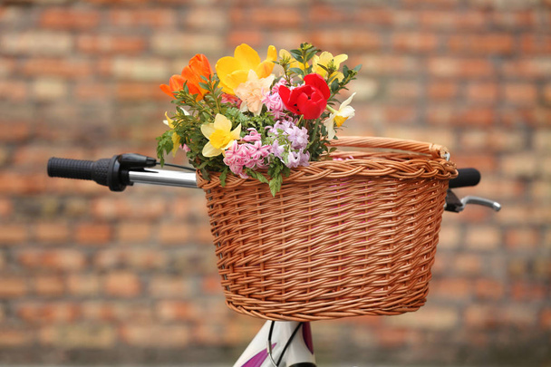 Bicycle with beautiful basket of flowers  - Фото, зображення