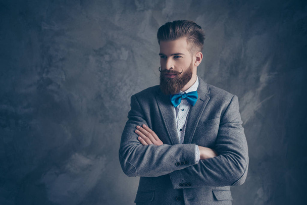 Confident stylish man in suit and bow with beard crossing his ha - Φωτογραφία, εικόνα