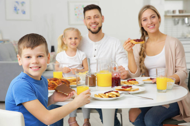 Happy family having breakfast on kitchen - Фото, зображення