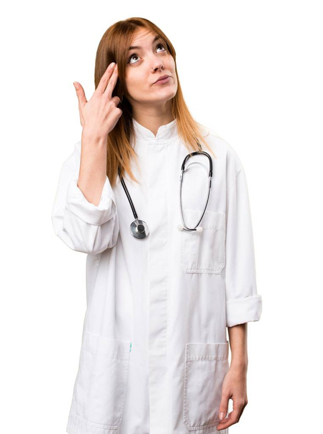 Young doctor woman making suicide gesture - Foto, Imagem