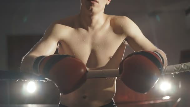 Handsome kickboxer resting in the gym - Video