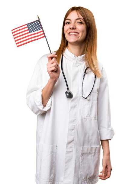 Young doctor woman  holding an american flag - Photo, Image