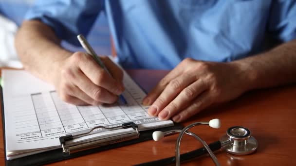 Doctor writing patient notes on a medical examination or prescription - Footage, Video