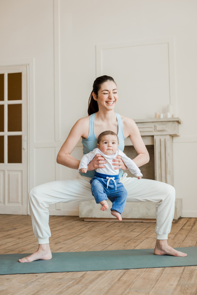 Mother with baby boy practicing yoga  - Photo, Image