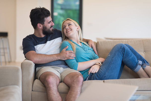 young happy couple relaxes in the living room - 写真・画像