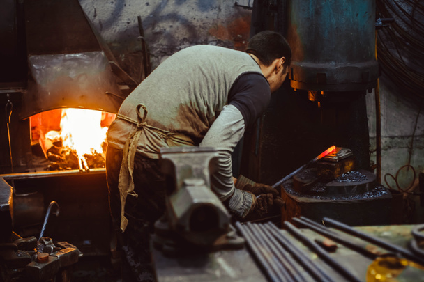 blacksmith working in the forge - Fotó, kép