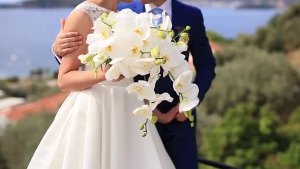 Hochzeitsstrauß aus Orchideen in den Händen der Braut, die sich in der - Filmmaterial, Video