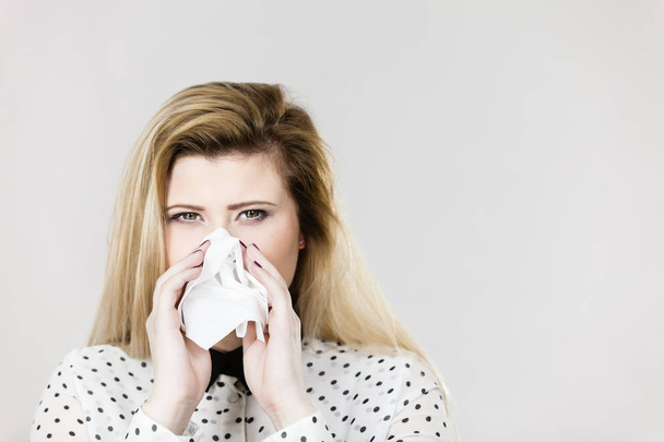 Woman being sick having flu sneeze into tissue - Photo, Image