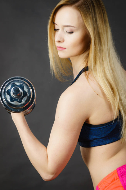 Fit woman lifting dumbbells weights - Фото, изображение