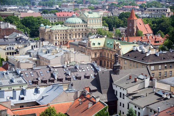 Aerial view of the roofs of houses in the historic part of Krakow with church of the Holy Cross, Juliusz Slowacki Theatre and other buildings. - Fotó, kép