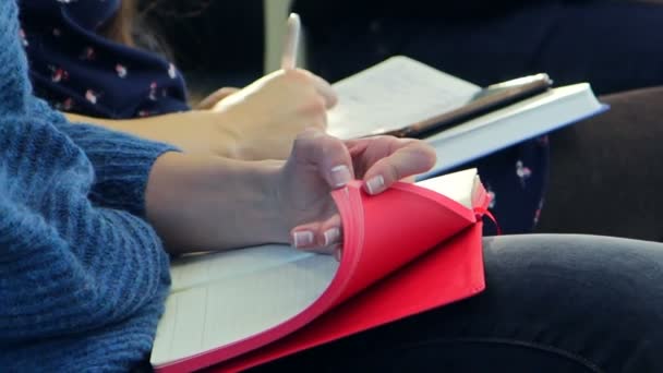 girl lazily scrolls notebook - Filmati, video