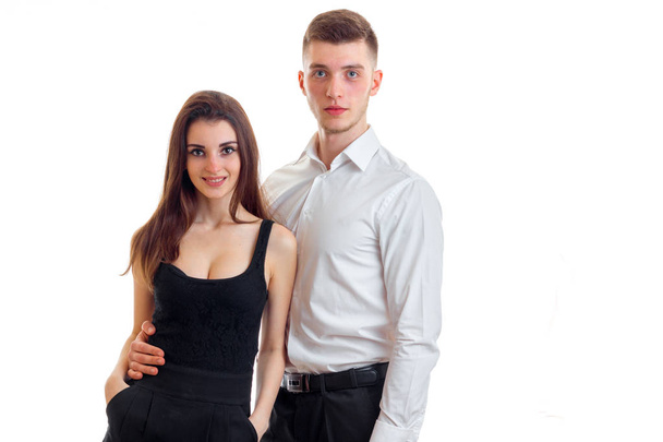 a charming young girl in a black dress next to a handsome guy in a white shirt - Photo, Image