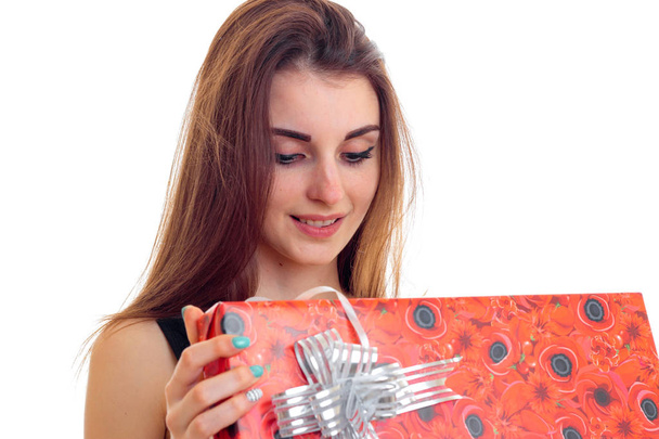 young girl holding a red Giftwrap and smiling isolated on white background - Φωτογραφία, εικόνα