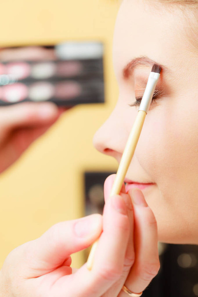 Close up woman getting make up, eyebrows - 写真・画像