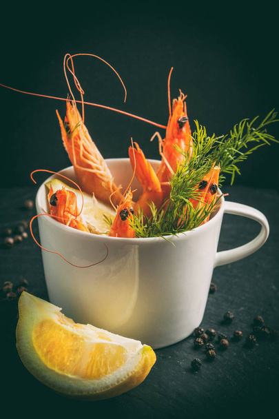 Shrimp in the cup on stone plate. - Foto, afbeelding