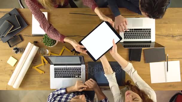 Top overhead view people group using and sharing tablet on a design project idea. Creative modern business team work meeting an at agency office. 4k indoor technology video - Filmagem, Vídeo