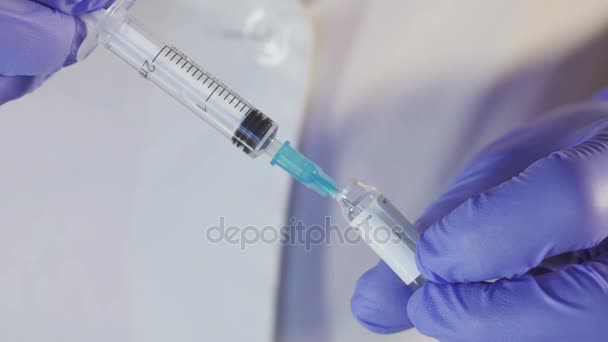 Doctor gaining medical syringe from the vial cap and close it. - Filmagem, Vídeo