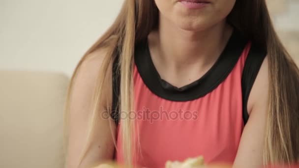 young woman eating rolls with chopsticks during dinner at the restaurant - Video, Çekim