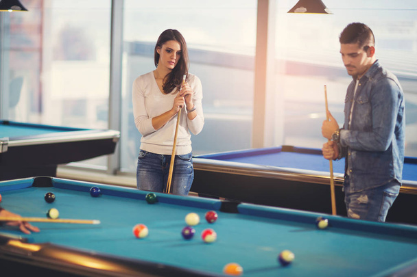 Group of young friends playing billiard - Photo, Image