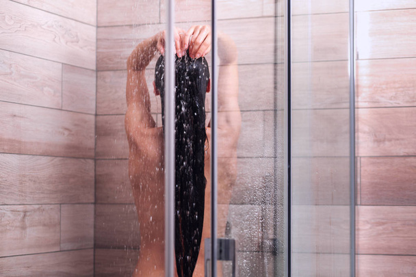 Young beautyful woman under shower in bathroom - Foto, imagen