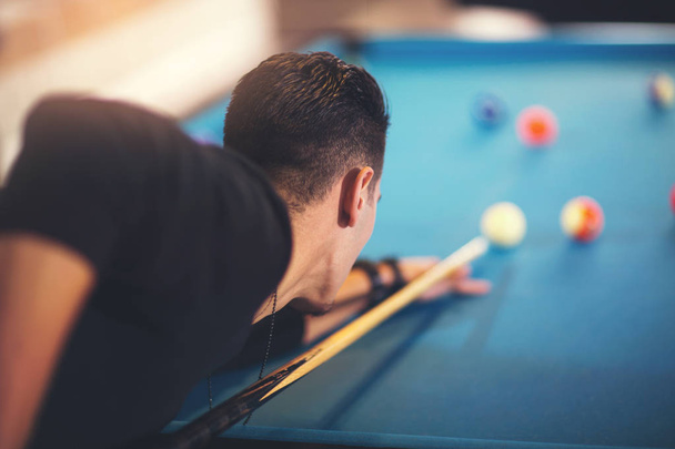 Handsome man playing pool in pub - Photo, Image