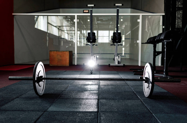 Barbell on floor in gym - Foto, afbeelding