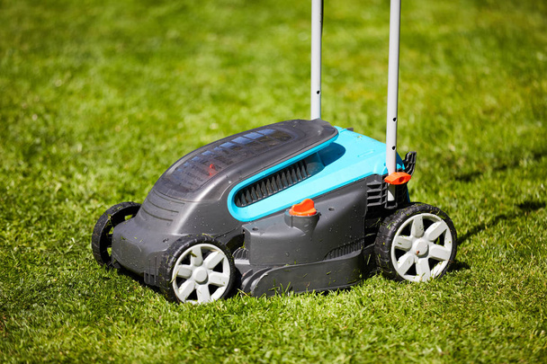 Lawn mower in the garden after mowing - Photo, Image