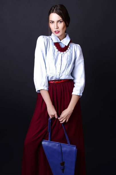 Elegant girl in denim blouse and red skirt in studio on white background - Фото, изображение