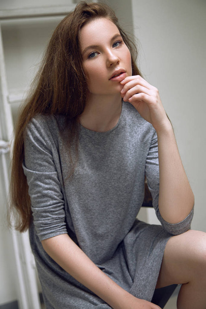 Brunet cheerful young woman. Beauty portrait. Long chic elegant hair. Model tests. Young girl - Фото, зображення