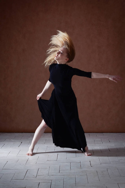 Modern ballet dancer posing on dark background - Fotografie, Obrázek