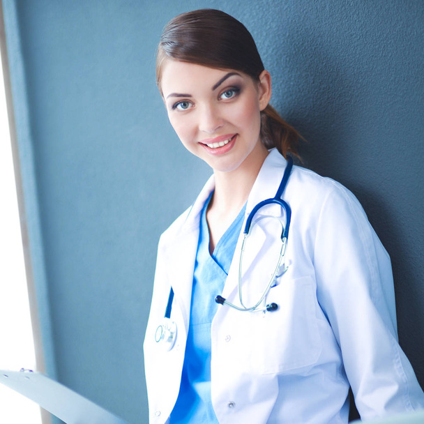 Female doctor working sitting on gray  background - Fotografie, Obrázek