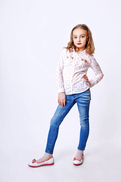 Cute little girl with red lips posing in studio - Photo, image