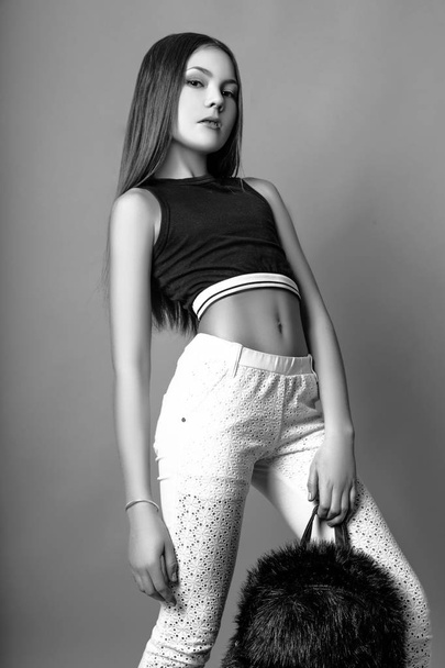 Cute girl teenage with long hair posing studio nature portrait. Black and white - 写真・画像
