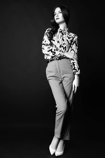 Studio photo of young woman on black background. Black and white - Valokuva, kuva