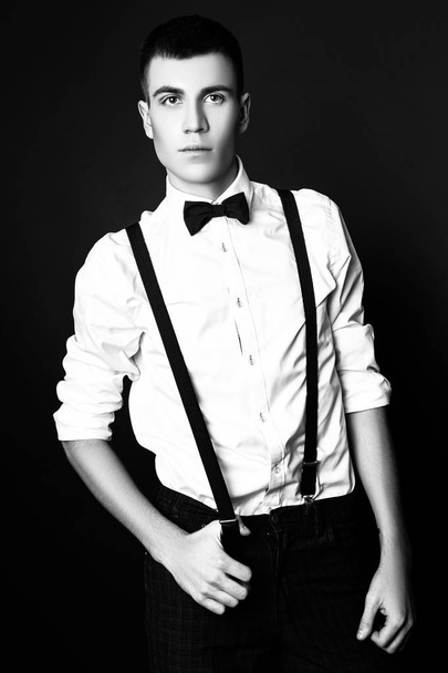 Fashion photo of young model man on black background. Boy posing. Studio photo. Black and white - Foto, immagini