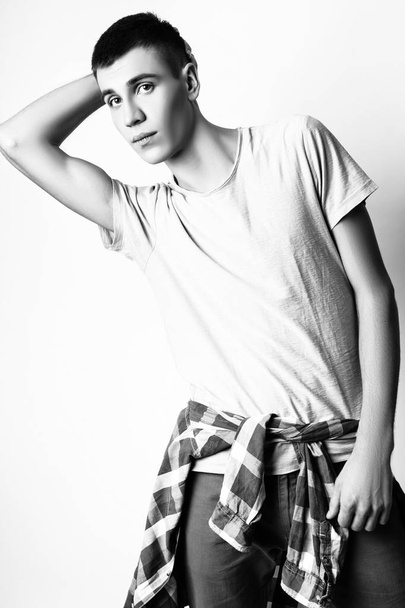 Fashion photo of young model man on white background. Boy posing. Studio photo. Black and white - Фото, зображення