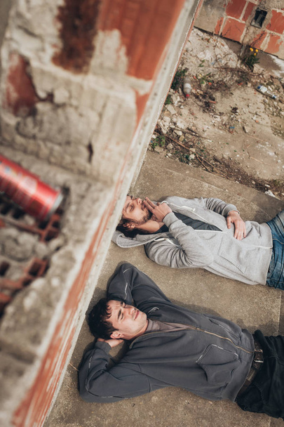 Two friends lying on the ground and smoke grass - Fotoğraf, Görsel