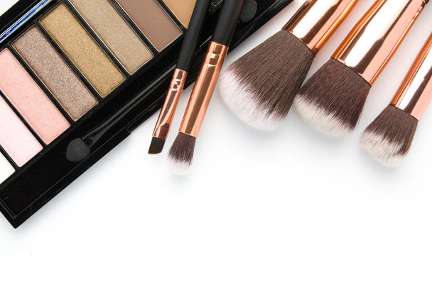 Makeup brush set with eye shadow palette on white   - Fotografie, Obrázek