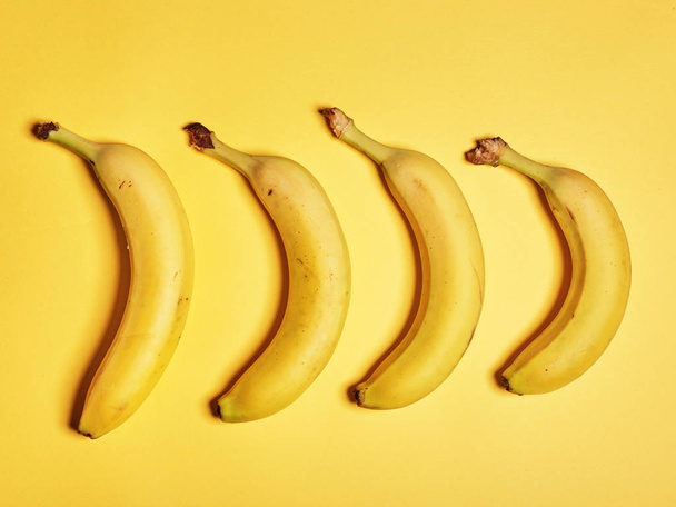 Bananas on a yellow background - Foto, imagen