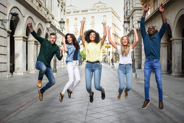 Group of friends jumping together outdoors - Fotoğraf, Görsel