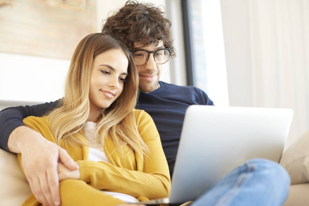 couple using laptop at home - Fotó, kép