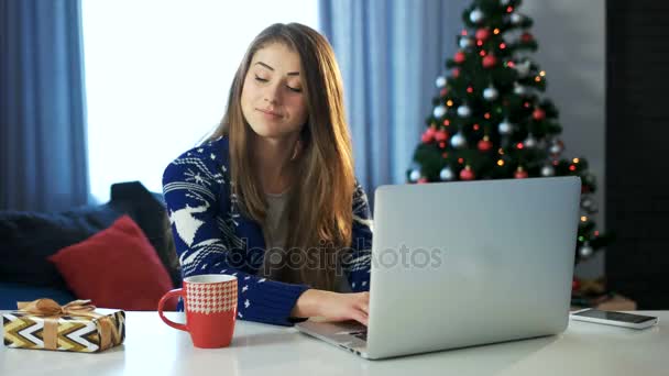Girl holding gift box working on notebook.C hristmas and happy new year. - Πλάνα, βίντεο