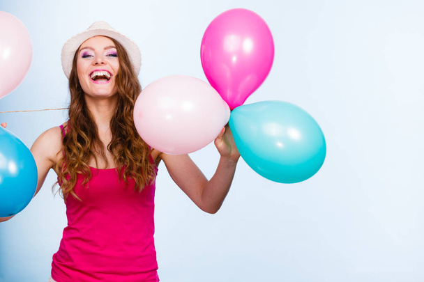 Woman playing with many colorful balloons - Foto, Imagen